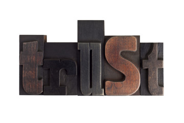 trust, word written in letterpress type blocks