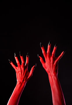 Red devil hands with black nails, real body-art