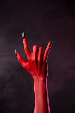 Red devil hand showing heavy metal gesture