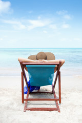 Woman on a tropical beach with hat