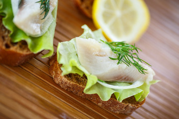 salted herring with onion rings and dill