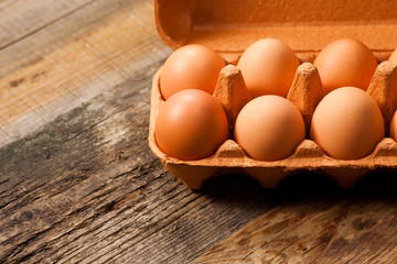 Eggs in the package on wooden table