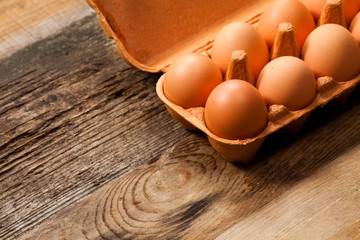 Eggs in the package on wooden table