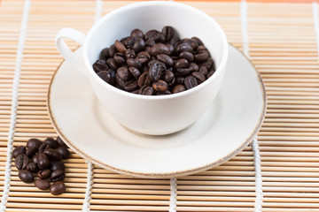 A cup and coffee beans, from above