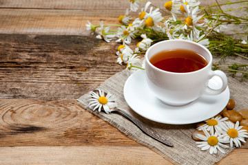 Obraz na płótnie Canvas herbal tea with chamomile on old wooden table