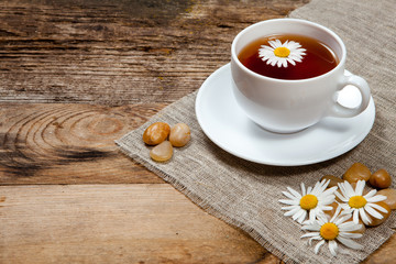herbal tea with chamomile on old wooden table