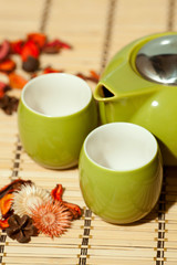Empty tea cups with teapot on table