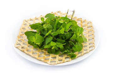 Pepermint on wickerwork dish white background