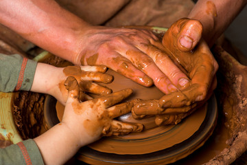 hands of a potter, creating an earthen jar
