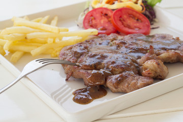 Pork steak in white plate