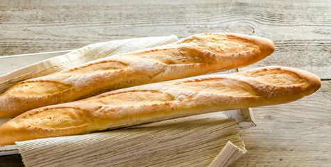 Two baguettes on the wooden tray