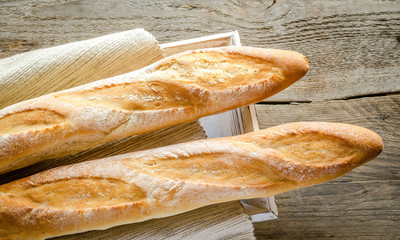 Two baguettes on the wooden tray