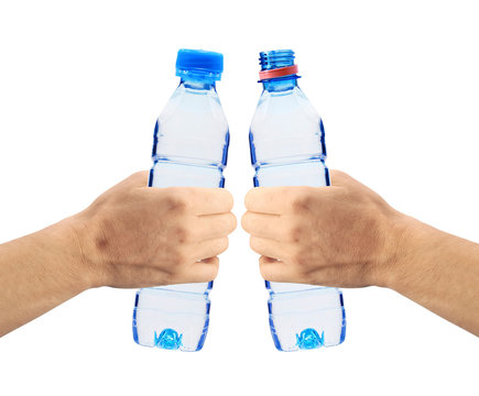 Human hands holding bottles of water isolated on white
