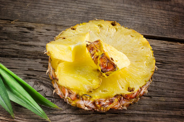 Pineapple. Slice and chunks on wooden table