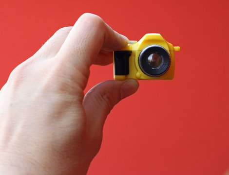 photographer while on a self-timer with a small toy camera