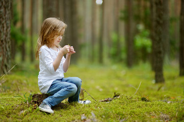 Adorable little girl hiking in the forest © MNStudio
