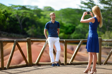 Young couple sightseeing Chamarel coloured earths