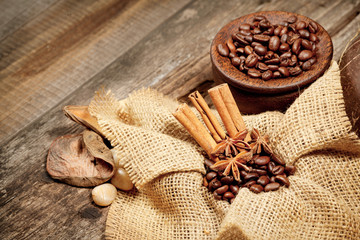 Cinnamon, star anise and coffee beans on old wooden table
