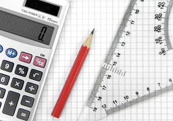 Calculator, lead pencil and ruler on squared paper