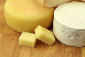 Various cheeses on wood background