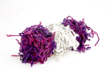 Three Isolated Balls of Pink and White Fuzzy Wool