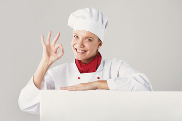 Young beautiful girl in a suit smiling chef
