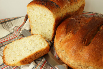 Freshly baked bread a few species and knife.