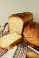 Freshly baked bread a few species and knife.