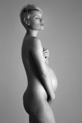 Tuinposter Nude portrait of the young pregnant woman.Studio shoot © sarymsakov.com