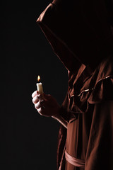wizard in black cape with candle