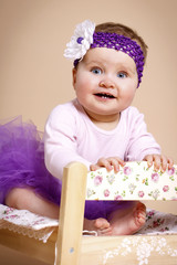 Little adorable little  baby with headband sitting on the bed © allari