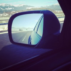 free highway/motorway in a mirror of blue modern car