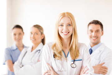 Fototapeta premium female doctor or nurse in front of medical group