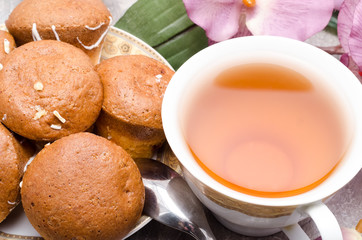 cup of tea with cookies on a plate
