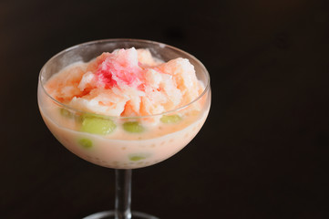 Shaved ice with syrup plus fruit  and milk .