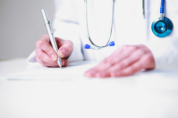 Photography closeup of a female doctor writing a prescription