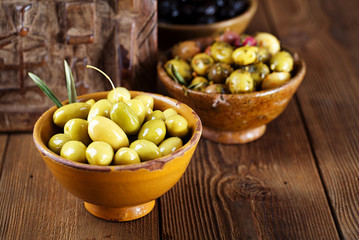 marinated Olives in bowls with moroccan  ornament on wood