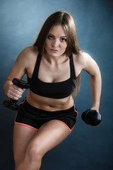 Fototapeta premium Fitness girl training shoulder muscles lifting dumbbells