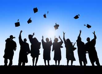 Silhouette of Graduating Students Throwing Caps In The Air