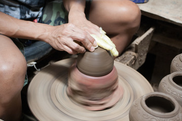 male hand sculpture pot in pottery