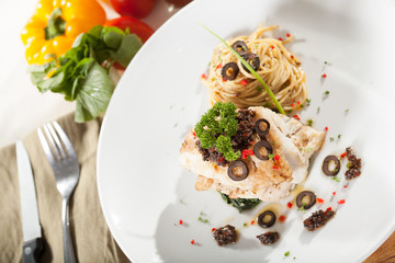 fish steak, decorated fish steak with spinach side spaghetti