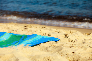 Summer vacation. Empty blue green mat on the beach