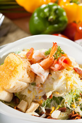 shrimp salad, vegetable salad on top with cooked shrimp