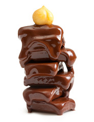 Pieces of chocolate, with drops and nut on a white background