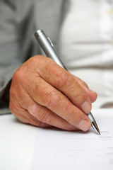 older woman signing the document