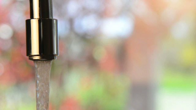 Drinking water flowing from a faucet open