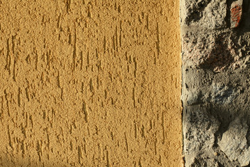 Yellow textured whitewashed wall in natural light © Costin79