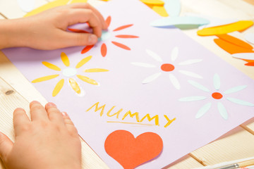 Unrecognizable child makes card
