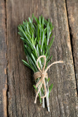 bunch of rosemary on wooden surface