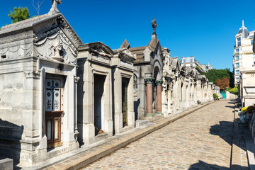 Old stone tombs in Montmartre Cemetery in summer, Paris, France